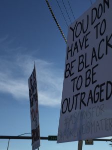 Demonstrators wave signs in midtown Anchorage in support of Black Lives Matter. (Hillman/Alaska Public Media)