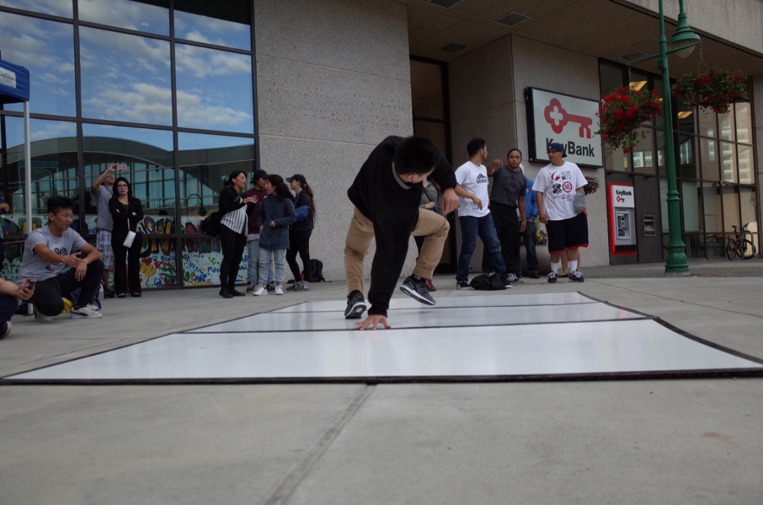 Ives Viray, one of the breakdancers with Anchorage Artist Co-Op, demonstrates his skills in downtown Anchorage)