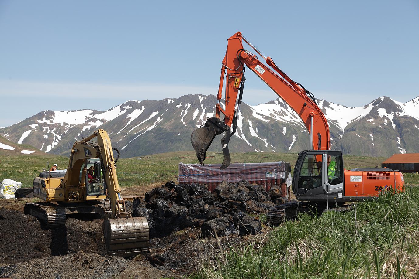 Two excavators dig up contaminated soil and old, rusted diesel drums on June 20 at Attu Island. (Photo courtesy of Dena O'Dell / USACE-Alaska District Public Affairs)