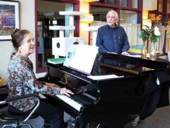 Jacque Farnsworth and Jack Brandt play for Juneau Pioneer Home residents earlier this year. (Photo by Lisa Phu, KTOO - Juneau)