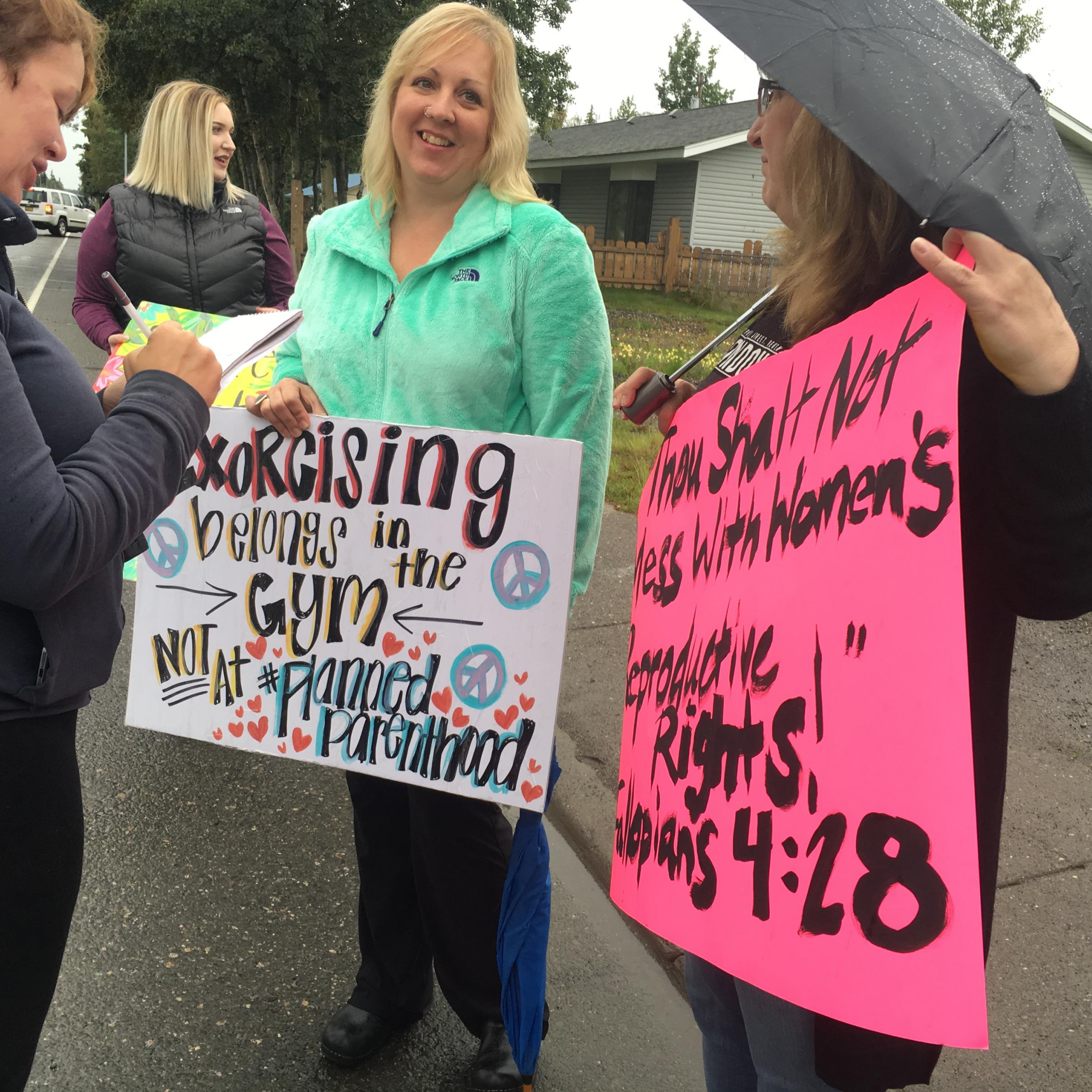 Reporter Elizabeth Earl with the Peninsula Clarion Newspaper interviews counterprotesters in front of the Soldotna Planned Parenthood on Aug. 17. (Photo by Daysha Eaton, KBBI - Homer)