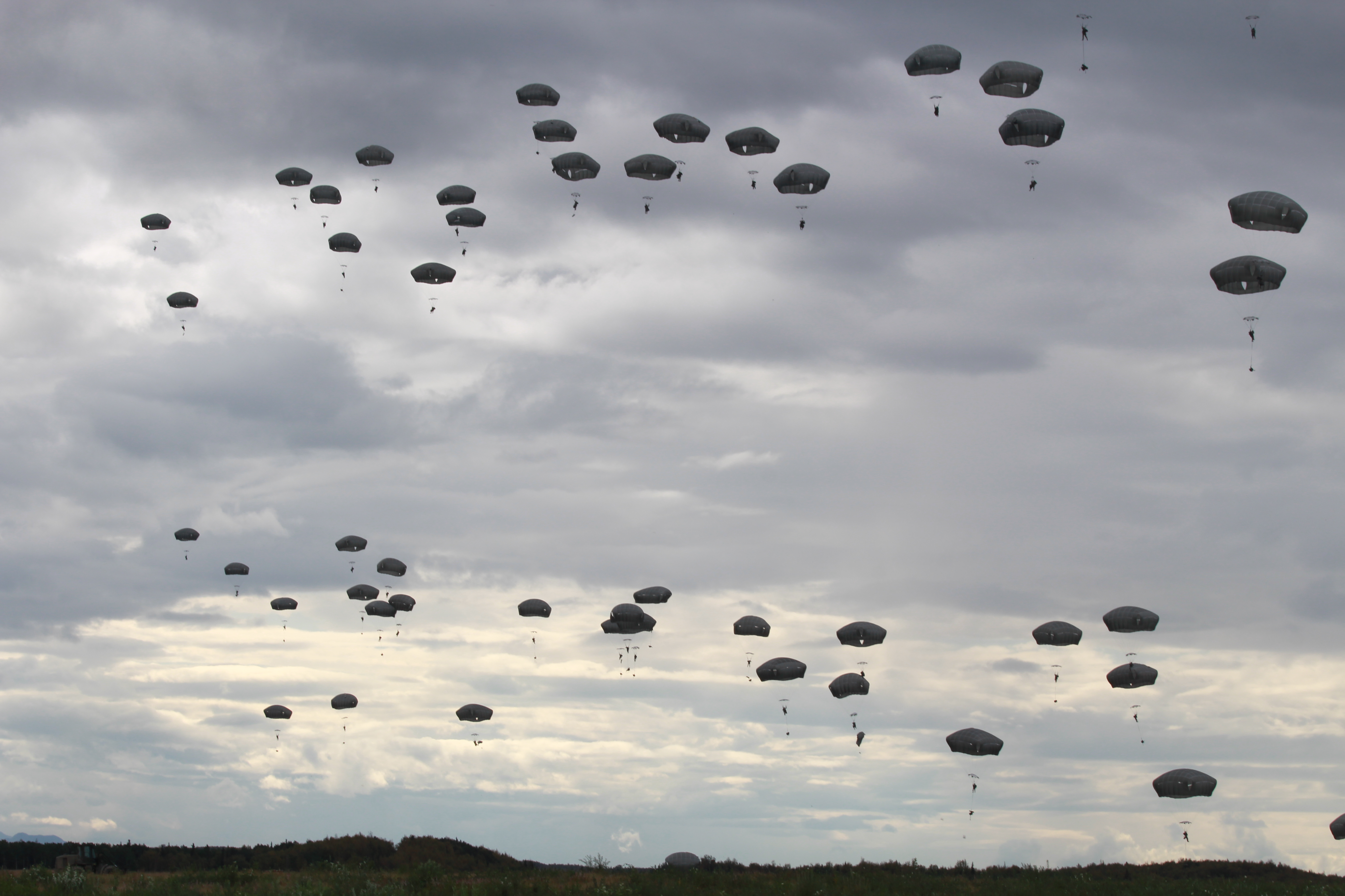 Paratroopers dropping over Fort Richardson (Photo by Wesley Early, Alaska Public Media - Anchorage)
