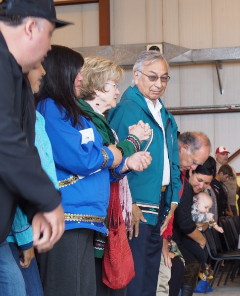 Around 200 people attended the dedication ceremony, including Willie Hensley, pictured here in the green atikłuk. (Photo: Zachariah Hughes, Alaska Public Media - Kotzebue)