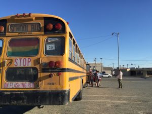 Participants load the bus for the LGBTQ history bus tour outside of the Raven. (Hillman/Alaska Public)
