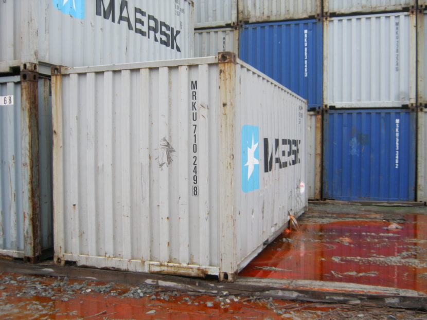 Fish oil pours out of the punctured shipping container. (David Tonon/U.S. Coast Guard)