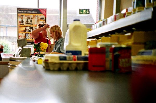 Essential groceries like milk and eggs slide down a conveyor belt to be purchased.