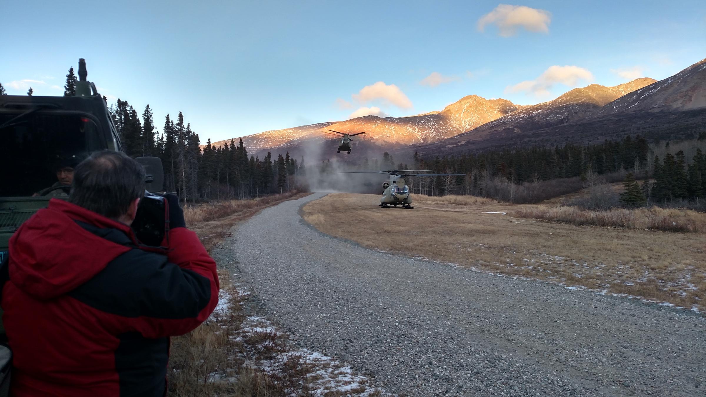 A second Chinook helicopter carrying U.S. and Canadian general/admiral-ranking officers and their staffs kicks up dust Tuesday upon landing at Black Rapids Training Site after a flight from Eielson Air Force Base. (Photo by Tim Ellis, KUAC - Fairbanks)
