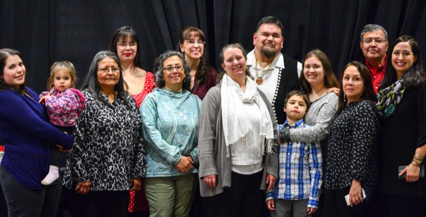 Alfie Price, sixth from the right, poses with family and friends after he was honored as a language warrior during a Nov. 22, 2016, awards ceremony. (Photo courtesy Central Council of Tlingit and Haida Indian Tribes of Alaska)