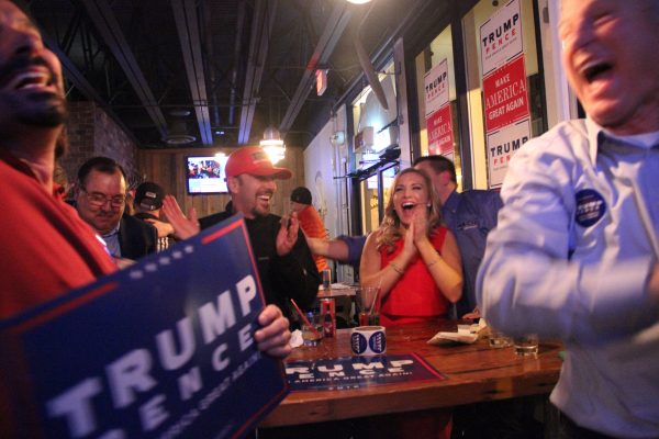George LaMoureaux, statewide volunteer coordinator for the Trump campaign, celebrated with his daughter, Ashley LaMoureaux, at Flattop Pizza in downtown Anchorage. (Photo by Rachel Waldholz/Alaska's Energy Desk)