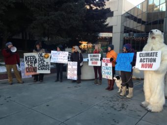 Protesters with the Center for Biological Diversity in front of BLM offices in downtown Anchorage. (Photo by Elizabeth Harball, Alaska’s Energy Desk - Anchorage)