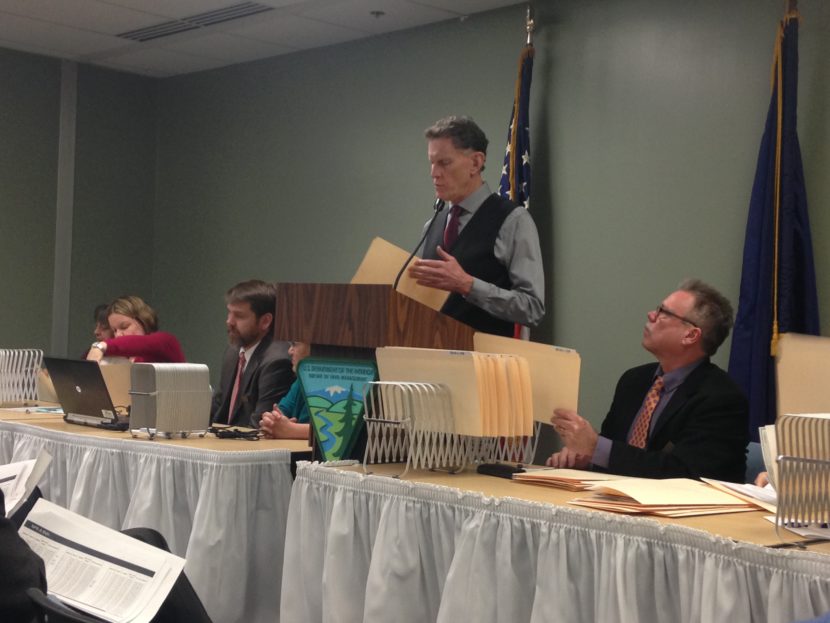 Ted Murphy, associate state director of the Bureau of Land Management in Alaska, reads off winning bids for the 2016 oil and gas lease sale for the National Petroleum Reserve-Alaska. (Photo by Elizabeth Harball, Alaska’s Energy Desk - Anchorage)