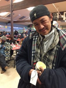 William Foster holds some of the ornaments he helped make at Bean's Cafe as part of a project funded by the Alaska Mental Health Trust Authority. (Hillman/Alaska Public Media)