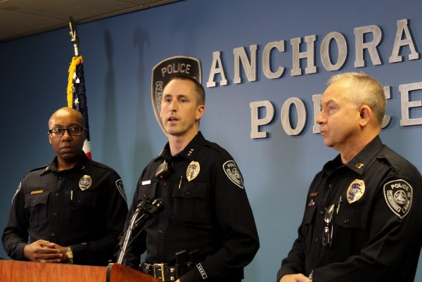 A white man in an officers uniform speaks at a podium