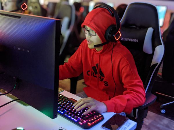A picture of East High School senior and team member Tom Cabanilla at his computer playing League of Legends during the playoff competition