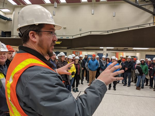 A structural engineer address the crowd on a tour of the damage at Gruening Middle School