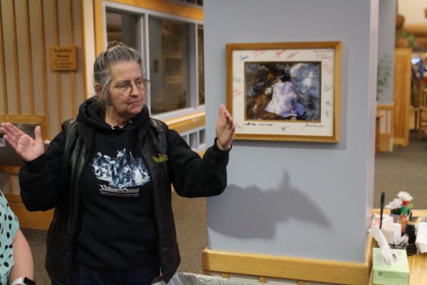 Marti Steury, executive director of the Yukon Quest for Alaska, explains dog drops at a community event in Fairbanks. When asked if she was worried about the smaller field, Steury said "No, not at all actually." (Lex Treinen/KUAC)