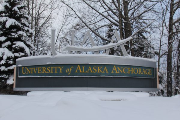 A sign says University of Alaska Anchorage in the snow