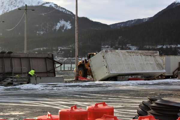 Crews attempt to turn over a trailer that was flipped over by wind at the subport lot downtown on Jan. 16, 2020. (Photo by Adelyn Baxter/KTOO)