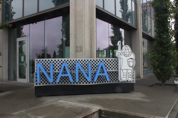 A glass building with the nana logo in front