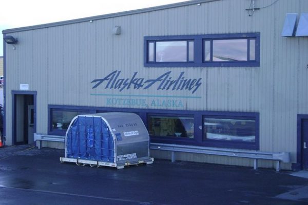 A beige building with the blue words Alaska Airlines