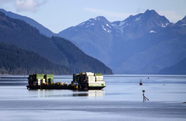 A barge filled with containers departs from the Alaska Marine Lines dock in downtown Juneau.