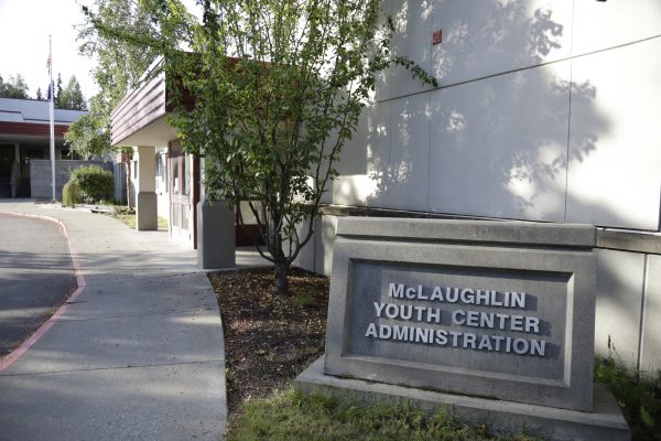 Sign in front of building that says "McLaughlin Youth Center Administration"