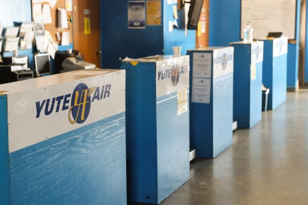 Blue ticket counters with the logo "Yute Air"' 