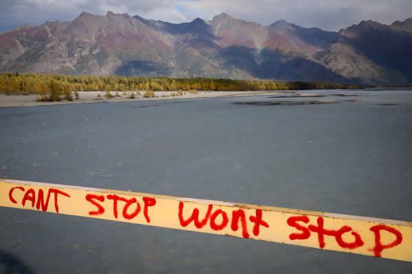 A message that reads "can't stop won't stop" in front of mountains and water