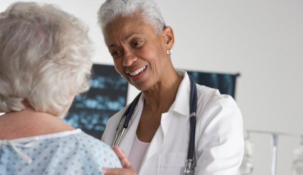 Female physician speaks with elderly woman