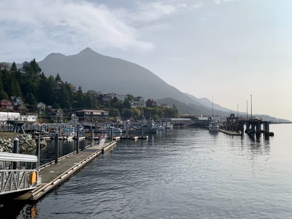 A harbor with a mountain in the background obscured by a light haze