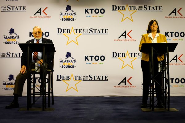 two people debating behind podiums