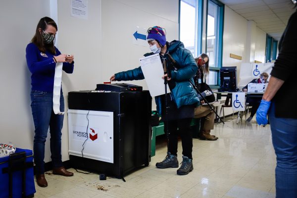 an election machine and some people on election day