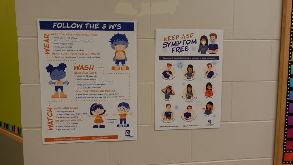 Signs in the hallways at Huffman Elementary School encourage mask wearing, hand washing and social distancing.