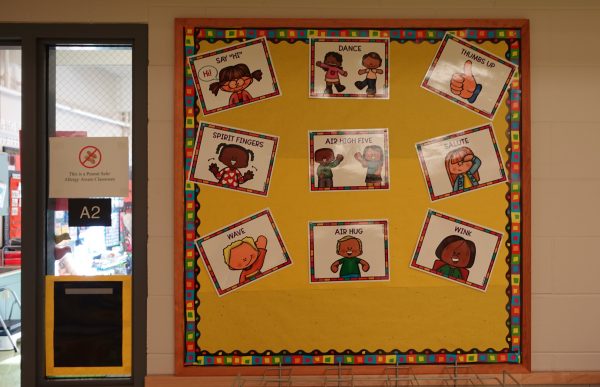 Huffman Elementary kindergarten teacher Katie McDaniel let’s her students decide how they want to be greeted each morning. Signs outside of her classroom show their options: dance, thumbs up, spirit fingers, air high five, salute, wave, air hug or wink.