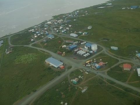 An aerial view of a small village nexxt to the ocean