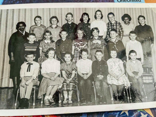 a class photo from 1960 of a teacher and students