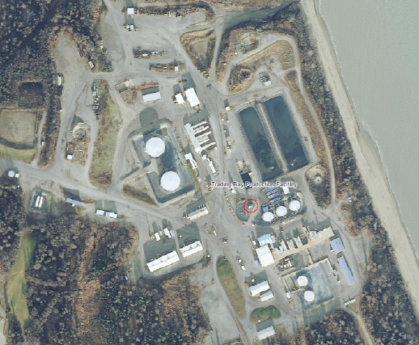 An aerial view of an oil production facilities shows a series of buildings near the Cook Inlet waters