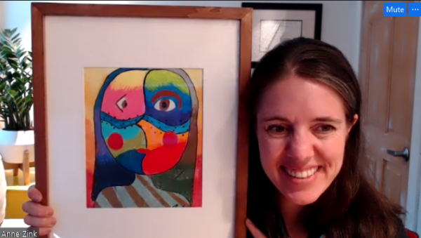 A white woman holds a colorful photo frame up to the camera