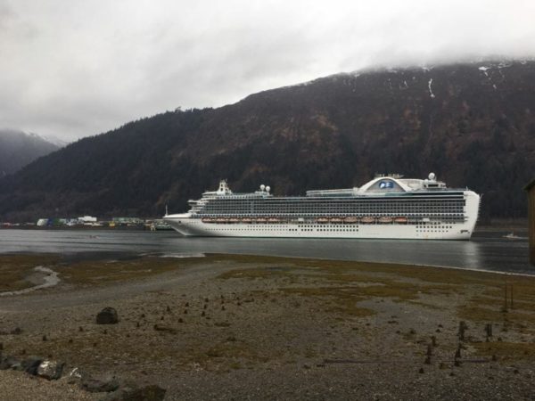 a cruise ship with a fog covered mountain inthe background