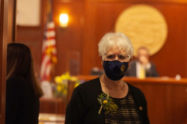 A white woman with a black mask