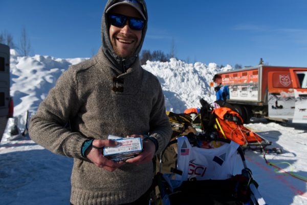 A musher holds empty vials of the COVID-19 vaccine.