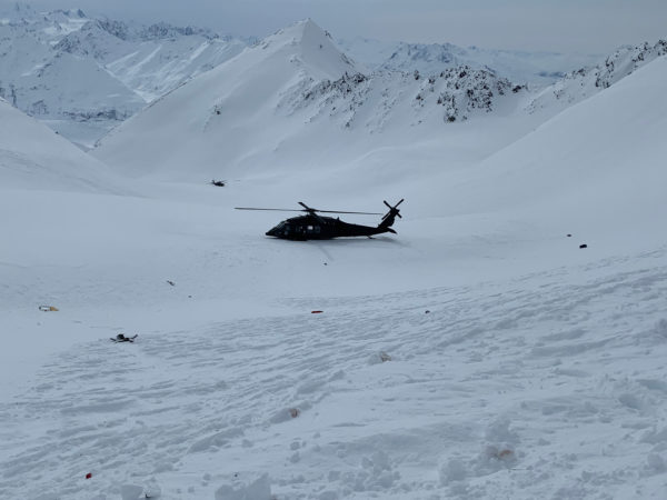 A helicopter on a mountainaouus snow field