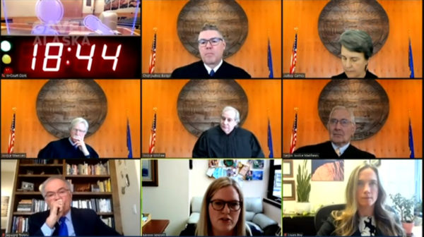 A zoom screen of a bunch of justices in front of State of ALaska seals