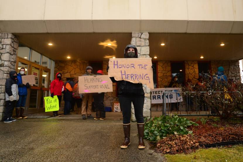 person holds a sign outside a courthouse
