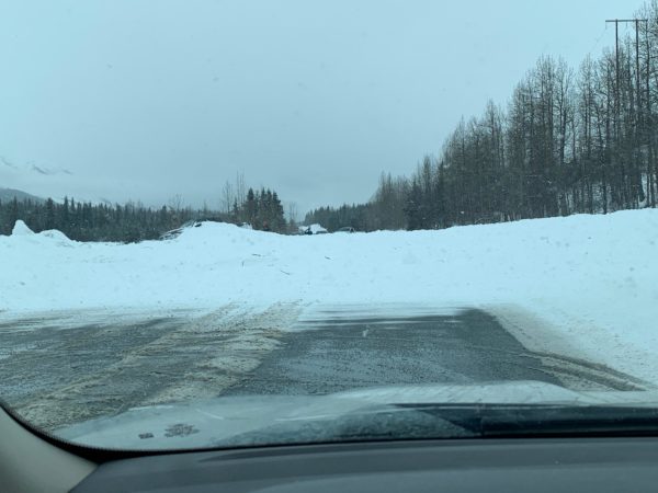 An avalanche over a road as seen from a windshield