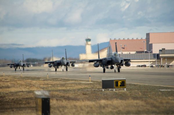 Fighter jets land on a runway