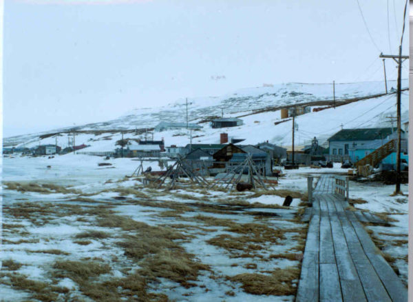A boardwalk surrounded by some scattered snow