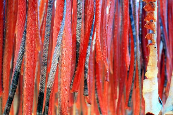 Bright-red, thin strips of salmon hang like streamers.