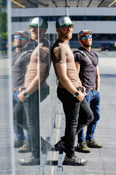 two people pose for a portrait against their mirrored reflection