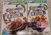 Two boxes of Cinnamon toast Crunch, the one of the left smaller than the one on the right.